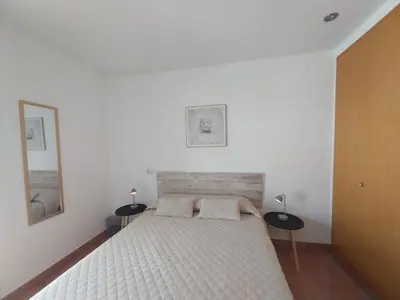 a bedroom with a white bed with two pillows at Casa Santa Úrsula in Casinos