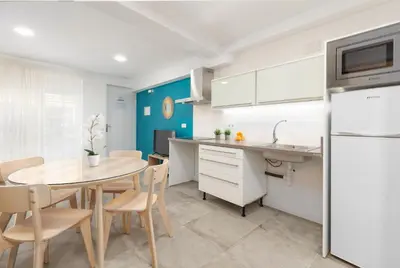 a kitchen and dining room with a table and chairs at Apartamentos Sol de Azahar in Valencia