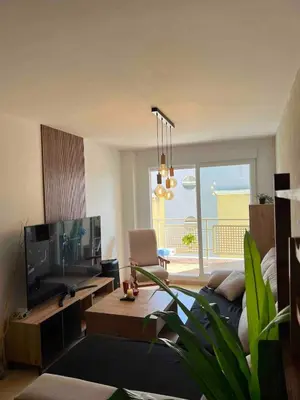 a living room with a couch and a tv at Apartment with the pool in Moncófar
