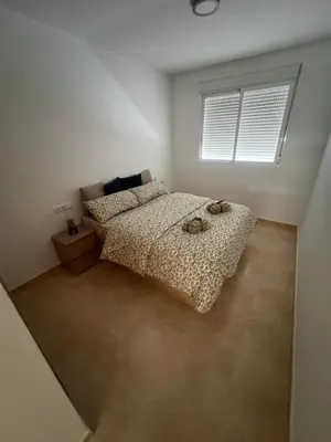 a bedroom with a bed with two shoes on it at Apartment with the pool in Moncófar