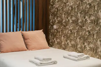 a bed with two folded towels on top of it at VLC HOST - Palleter in Valencia