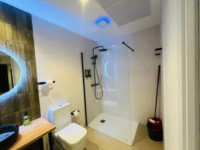 a bathroom with a toilet and a glass shower at Hotel con entrada independiente a pocos pasos de la Ciudad de las Artes y las Ciencias y el Oceanogràfic A solo 1 minuto caminando del Jardín del Turia in Valencia
