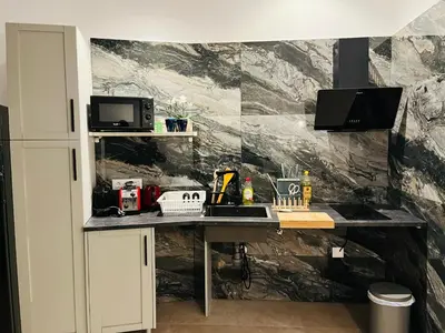 a kitchen counter with a sink and a microwave at Ubicación inmejorable Hotel privado junto a la Ciudad de las Artes y a un paso del Turia in Valencia