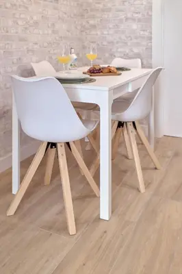 a white dining room table with two white chairs at Romantic Suite Roig Arena N10 Virkin Suites in Valencia