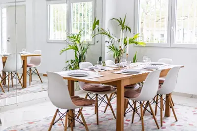 a dining room with a wooden table and white chairs at Casa Familiar 9 Pax, Smart TV, Centro, Playa, Café, AC in Valencia