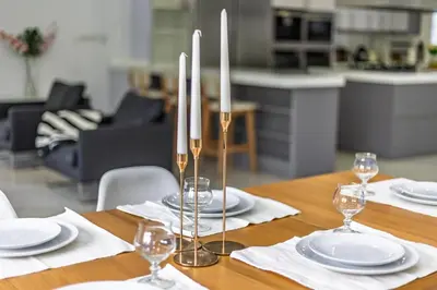 a table with white plates and silver candles on it at Casa Familiar 9 Pax, Smart TV, Centro, Playa, Café, AC in Valencia