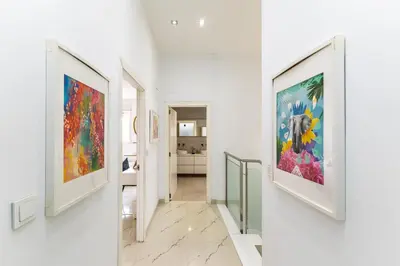 a hallway with three framed paintings on the walls at Casa Familiar 9 Pax, Smart TV, Centro, Playa, Café, AC in Valencia