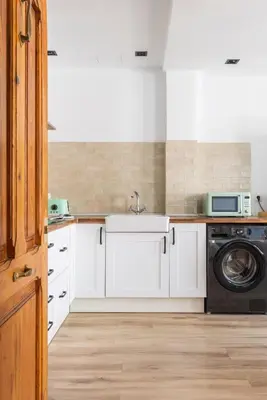 a kitchen with a sink and a washing machine at Luxury new apartment 10 min walk to the beach, Late Checkout in Valencia