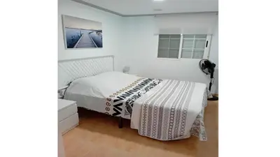a bedroom with a bed with a white comforter at Villa entre terre et mer in Montroy
