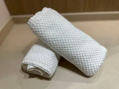 two pieces of white towels sitting on a floor at La fonda de Olympia in Valencia
