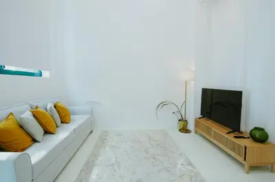 a white living room with a couch and a tv at Apartment 1 City of Arts and science Fast Wifi 1 in Valencia