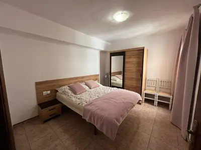 a bedroom with a bed with two pink pillows at Apartament Marina Cullera in Cullera