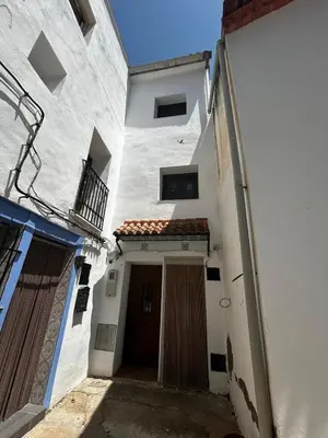 a white building with a door and a balcony at Vistas del Frailecico in Chulilla