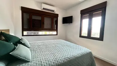 a bedroom with a bed and two windows at Vistas del Frailecico in Chulilla
