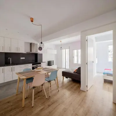 a kitchen and living room with a table and chairs at GuestReady - Homely escape in Valencia in Valencia