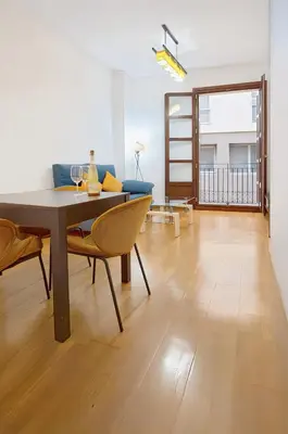 a living room with a table and a couch at Grand Central Market Suites By VALENCIAFLATS EU in Valencia