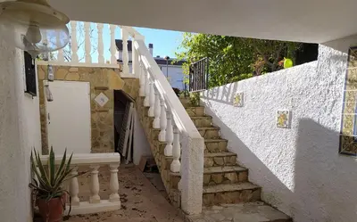a white stairway with a white door and a stair case at Ferienwohnung mit Privatpool Casa Wende in Benaguacil