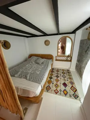 a small bedroom with a bed and a mirror at Charming fisherman's house Cabanyal Cabañal in Valencia