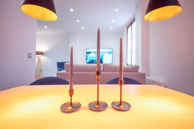 a table with three candles on top of it at El Pilar Luxury Suites By VALENCIAFLATS EU in Valencia