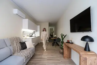 a woman is walking through a living room at Tao Suite 1 next to the Aquarium in Valencia