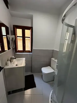 a white bathroom with a sink and a toilet at Piso 1 - Apartamento Mercado Central in Valencia