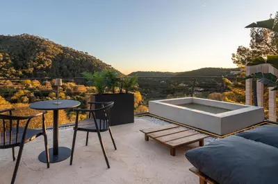 a patio with a tub and a table and chairs at Resort Serra Nature - Luxury Villas Hotel Boutique in Serra