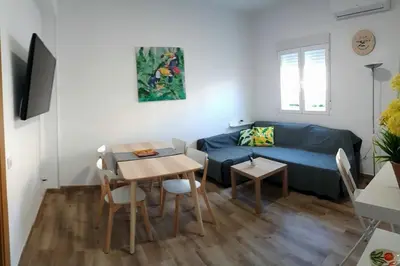a living room with a blue couch and a table at Malva Arena in Valencia