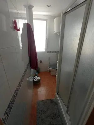a bathroom with a toilet and a glass shower door at Malva Arena in Valencia