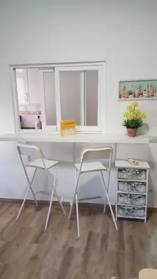 a white desk with two chairs in a room at Malva Arena in Valencia