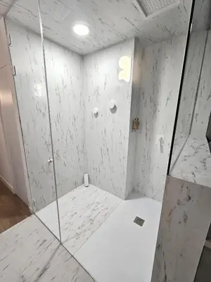 a shower with a glass door in a bathroom at Designer apartment facing the sea in Valencia