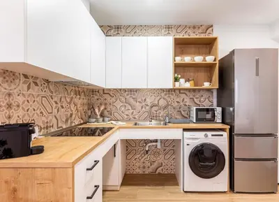 a kitchen with white cabinets and a washer and dryer at Balandra, Lovely flat close to center in Valencia