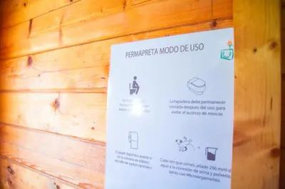 a sign hanging on a wooden wall at Cabaña madera en bosque 100 ECO in Petrés