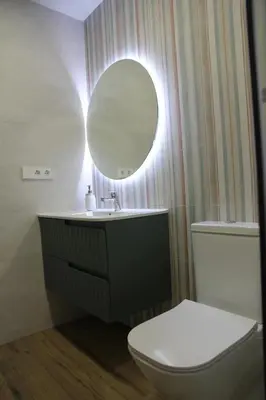 a bathroom with a toilet and a sink and a mirror at Ruzafa Acquamarina in Valencia
