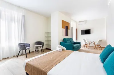 a bedroom with a bed and a living room at The Port Urban Loft in Valencia