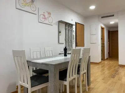 a dining room with a table and chairs at Sunrise Beach Apartment Playa Puerto de Sagunto in Puerto de Sagunto