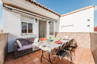 a patio with a table and a couch at Casa Las 4 Estaciones in Caudiel
