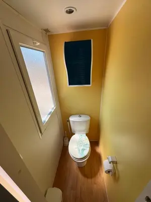a bathroom with a toilet in the corner of a room at Camping Los Naranjos in Moncófar