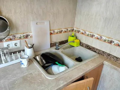 a kitchen sink with a dishes in it at Calle platano37 in Valencia