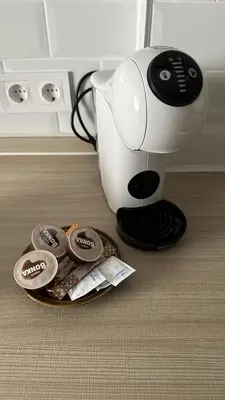a coffee maker sitting next to a plate of cookies at Apartamento Bahía Cullera I in Cullera