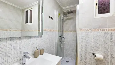 a bathroom with a shower and a sink and a toilet at Sagunto Beach Apartment 500m to Sea, WiFi 600Mb y AC in Puerto de Sagunto