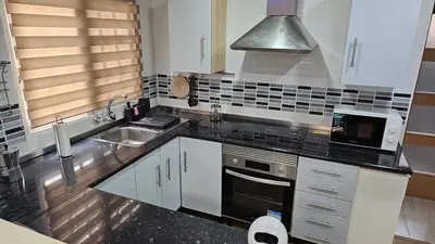 a kitchen with a sink and a stove top oven at Sagunto Beach Apartment 500m to Sea, WiFi 600Mb y AC in Puerto de Sagunto
