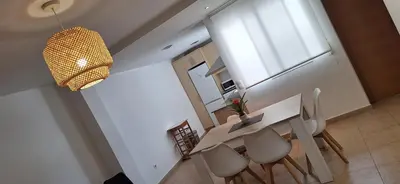 a dining room with a table and chairs and a window at Apartamento Cervantes in Benetúser