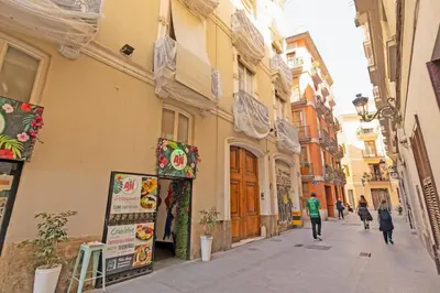 a street with people walking down a street at GuestReady - Charming place in Valencia in Valencia