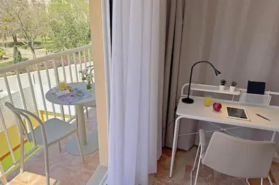 a room with a balcony with a table and a desk at SingularStays Palau de la Musica Lofts in Valencia