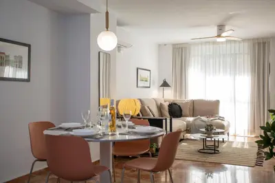 a living room with a table and a couch at SingularStays Palau de la Musica Lofts in Valencia