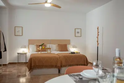 a bedroom with a bed and a table and chairs at SingularStays Palau de la Musica Lofts in Valencia