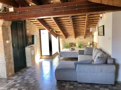 a living room with a couch and a bed at Beautiful penthouse with two terraces near the sea in Valencia