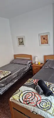 a room with two beds and two night stands at A fantastic apartment on the beach in Canet de Berenguer