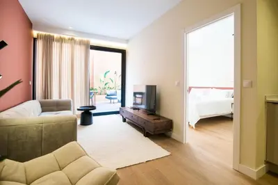 a living room with a couch and a bed at Apartamento moderno con terraza en el centro in Valencia
