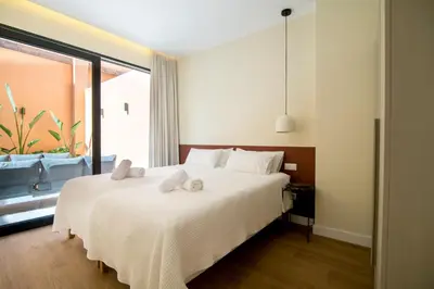 a bedroom with a large white bed with towels on it at Apartamento moderno con terraza en el centro in Valencia
